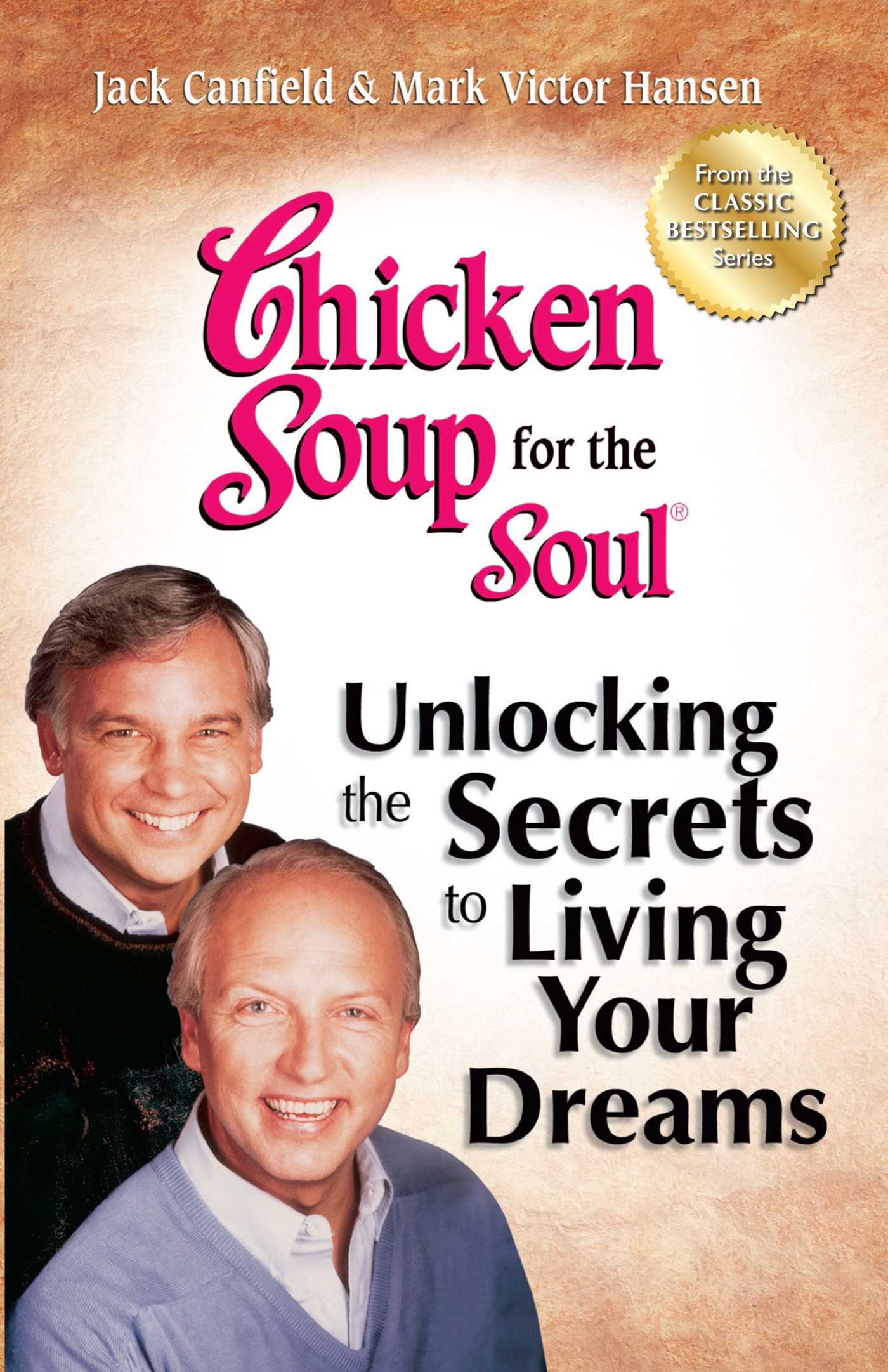 Book cover of "Chicken Soup for the Soul: Unlocking the Secrets to Living Your Dreams" by Jack Canfield and Mark Victor Hansen. The cover features photographs of the two authors smiling, with the title in bold red and black text. The top of the cover includes the phrase "From the CLASSIC BESTSELLING Series" in a gold circular badge. The background is a soft beige color.